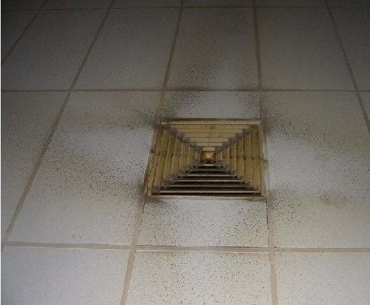 A dirty ceiling exhaust on the floor